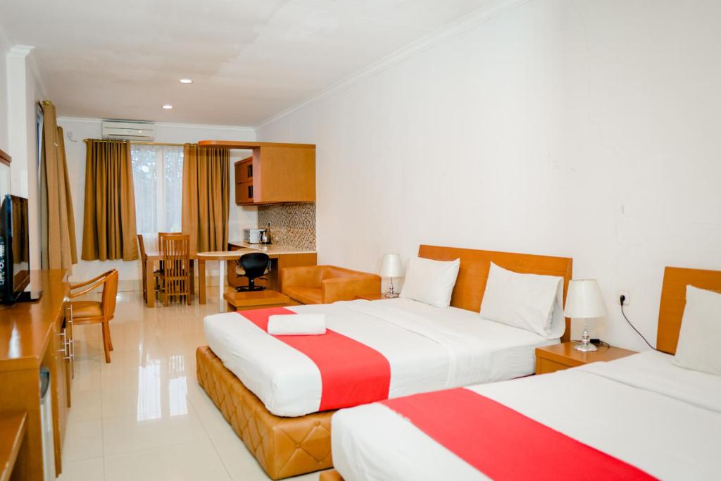 Postel nebo postele na pokoji v ubytování HOTEL & WISMA BINTANG JADAYAT