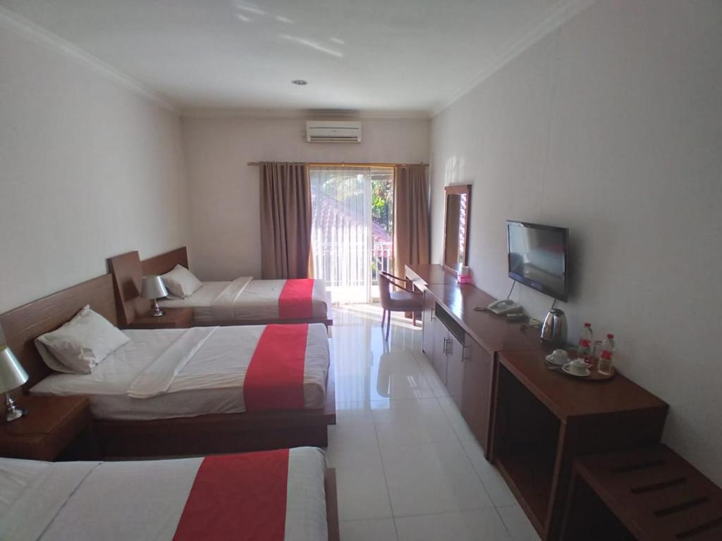 Postel nebo postele na pokoji v ubytování HOTEL & WISMA BINTANG JADAYAT