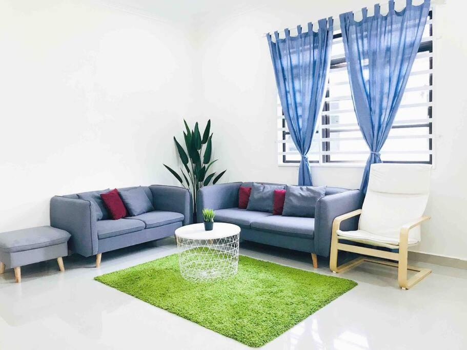 a living room with a blue couch and chairs at Danial Homestay Ajil in Ajil