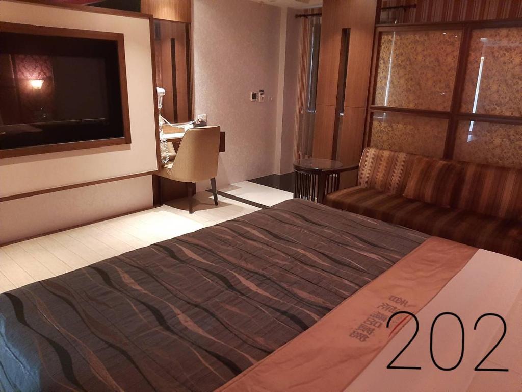 Postel nebo postele na pokoji v ubytování Chateau Motel & Spa (Daliao)