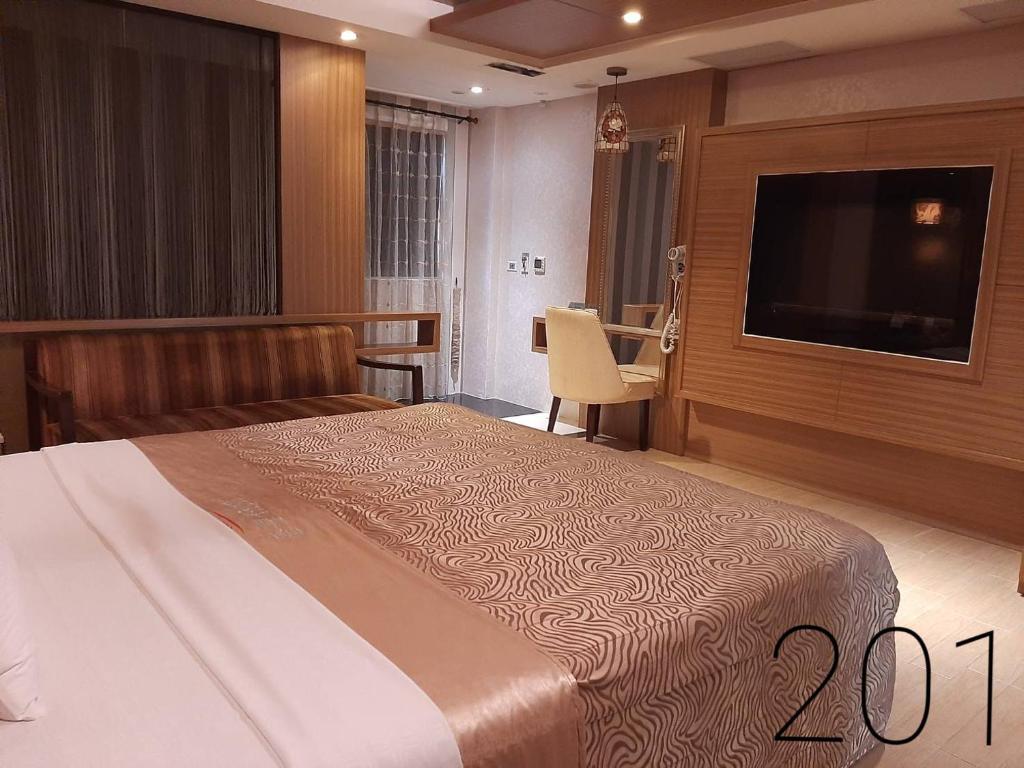 Postel nebo postele na pokoji v ubytování Chateau Motel & Spa (Daliao)