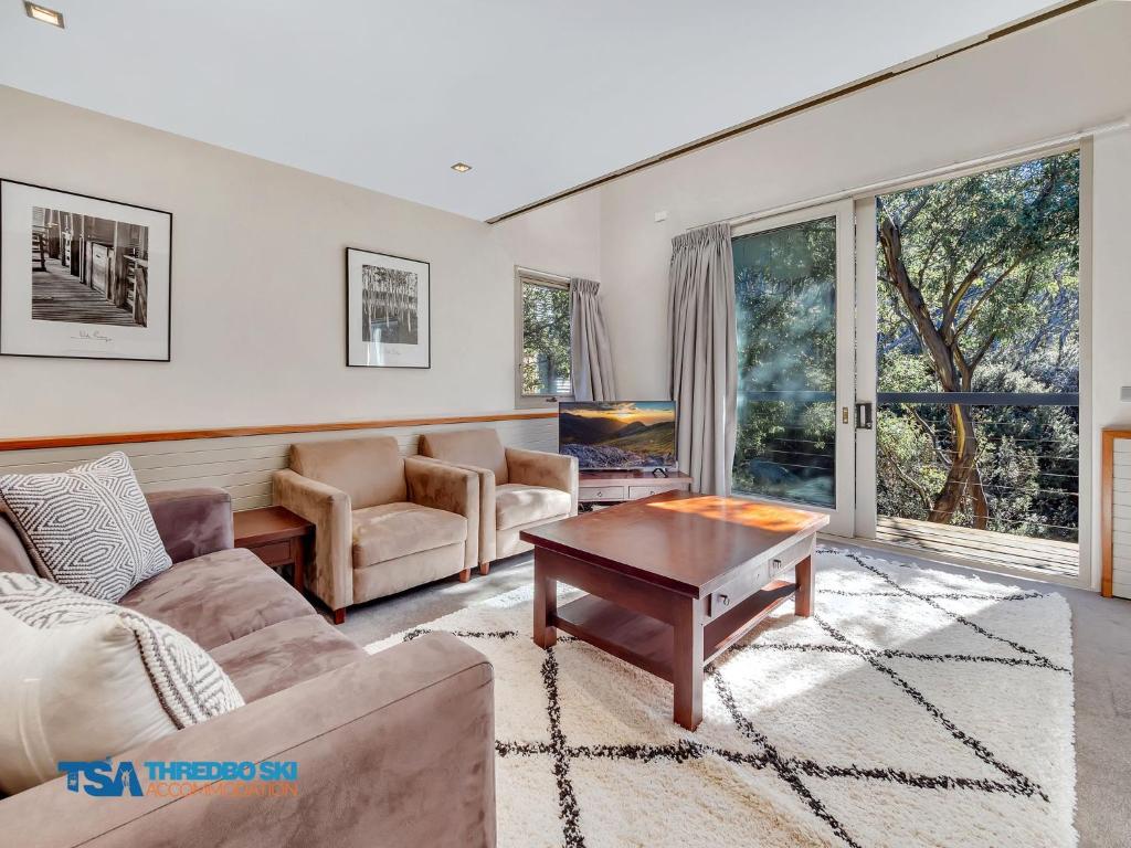 a living room with a couch and a table at Ramshead Creek 1 in Thredbo