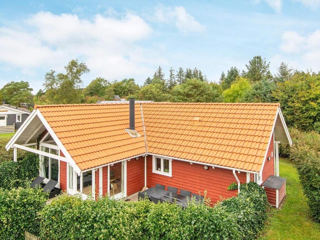 a red house with an orange roof at 6 person holiday home in Hemmet in Hemmet