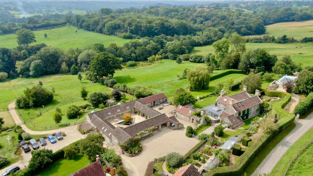 an aerial view of a house in a field at Upper Vobster Farm in Radstock