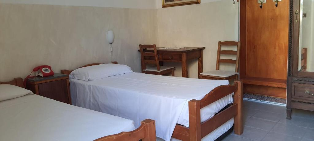 Posteľ alebo postele v izbe v ubytovaní Albergo Avalon