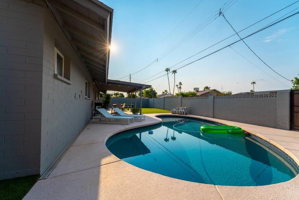 a swimming pool on the side of a house at Splash and Relax by HomeSlice Stays in Scottsdale