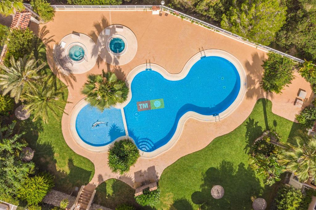 an overhead view of a pool with two swimming pools at Casa Hygge in Calas de Mallorca