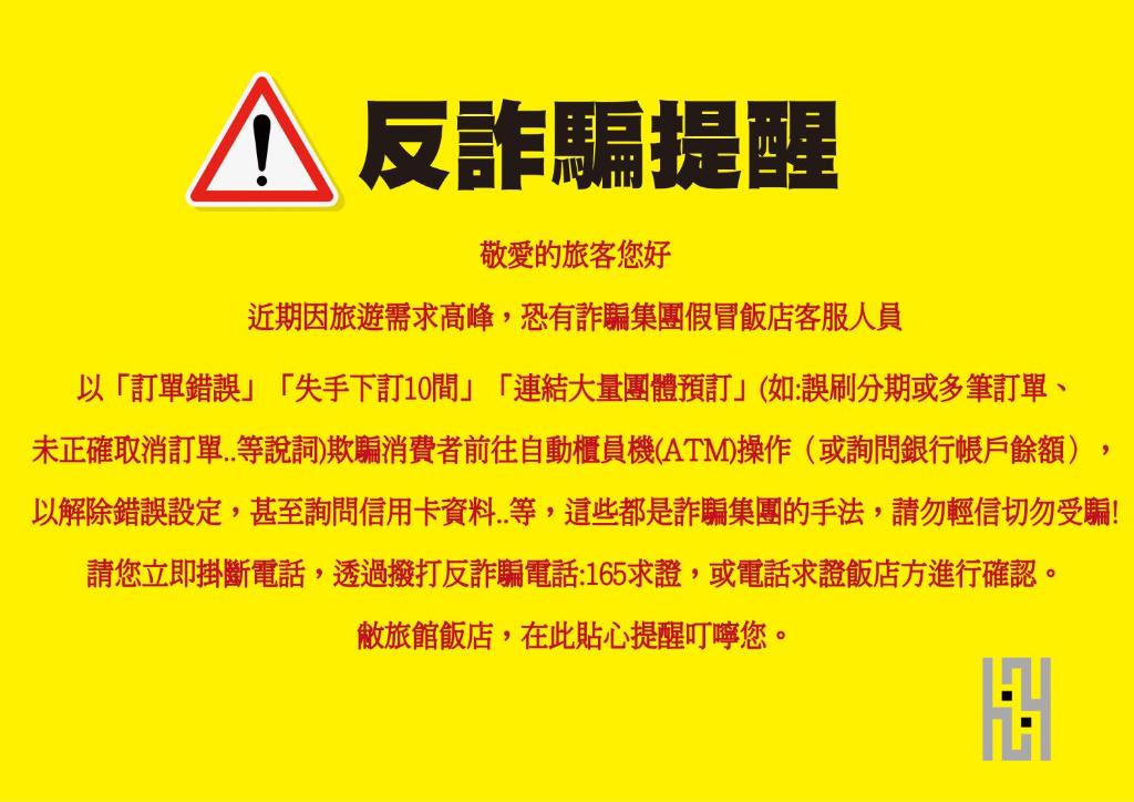 a danger sign withinese writing on a yellow background at HOTEL HI - Xinmin in Chiayi City