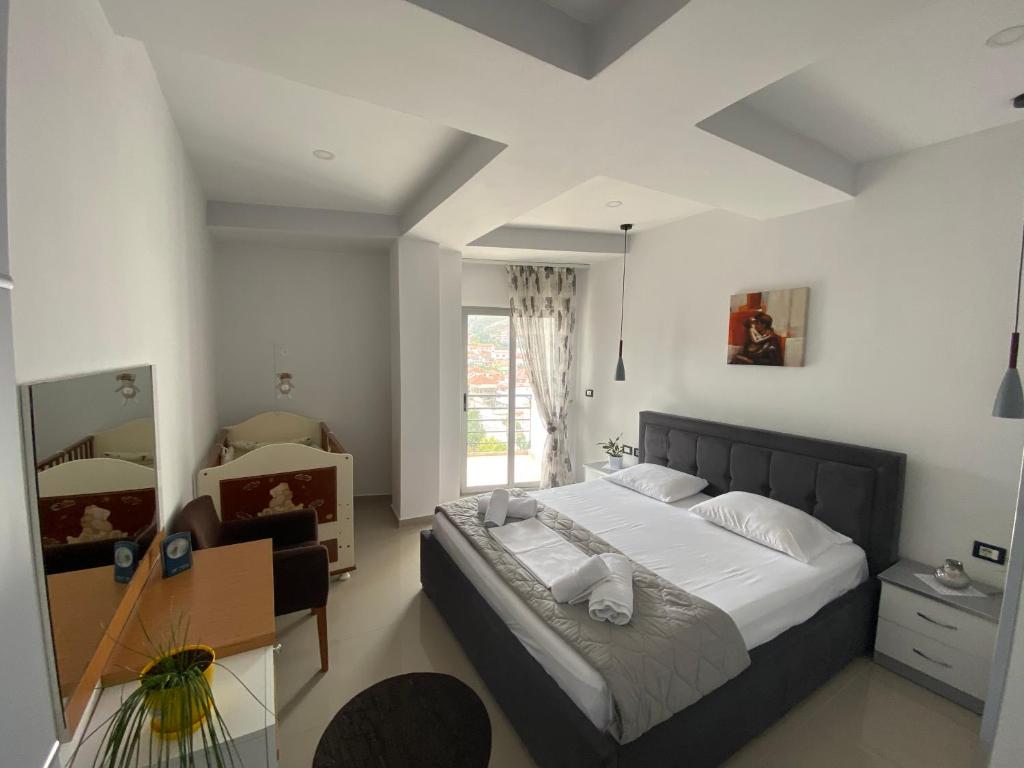 una camera con letto, scrivania e finestra di Guest's Apartament a Pogradec