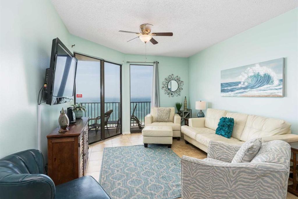 a living room with a couch and a flat screen tv at Phoenix East in Orange Beach