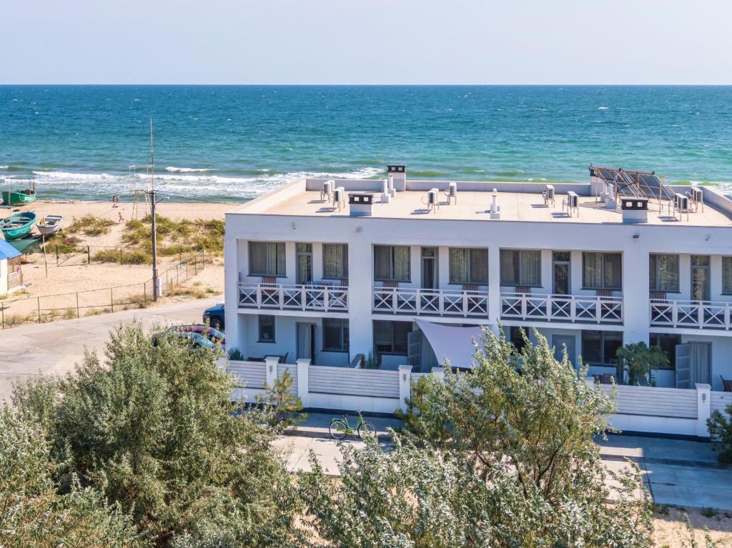 a white house on the beach with the ocean at Villa Aquamarin Buhaz in Zatoka