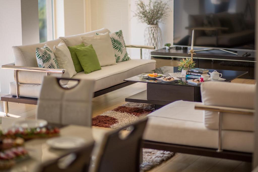 a living room with a couch and a coffee table at Spa Resort Luxury Apartments in Budva