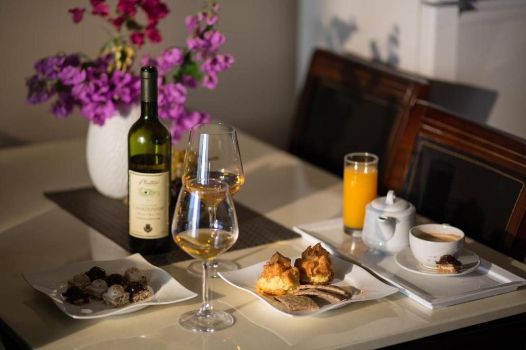 a table with a bottle of wine and a glass at Spa Resort Luxury Apartments in Budva