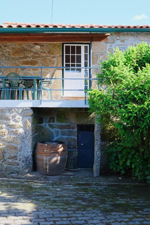 a building with a balcony and a blue door at Casa dos Limões in Arcos de Valdevez