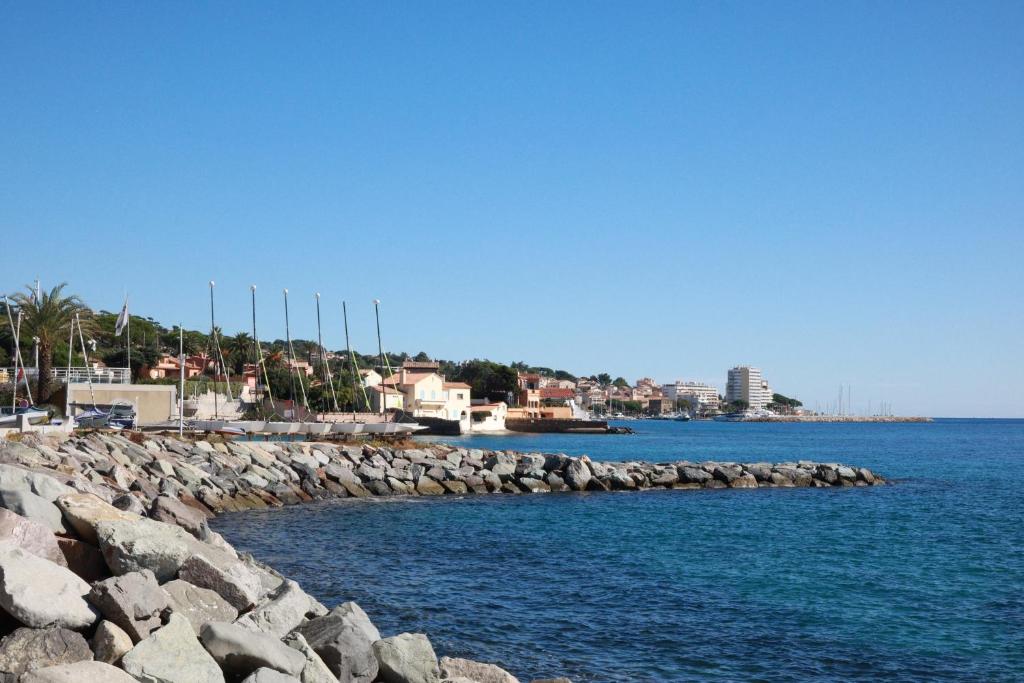 a large body of water with a rocky pier at Casa Del Mar - Beautiful Two Bedroom Penthouse Apartment in Sainte-Maxime