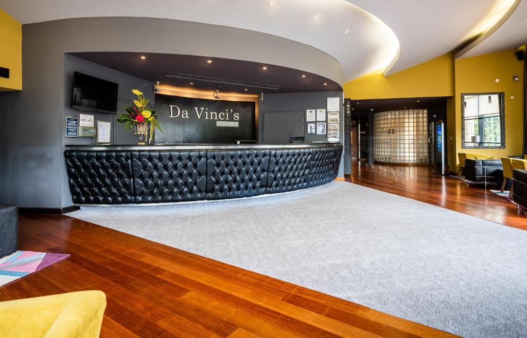 a lobby with a bar in a building at Da Vinci's Hotel in Derry Londonderry