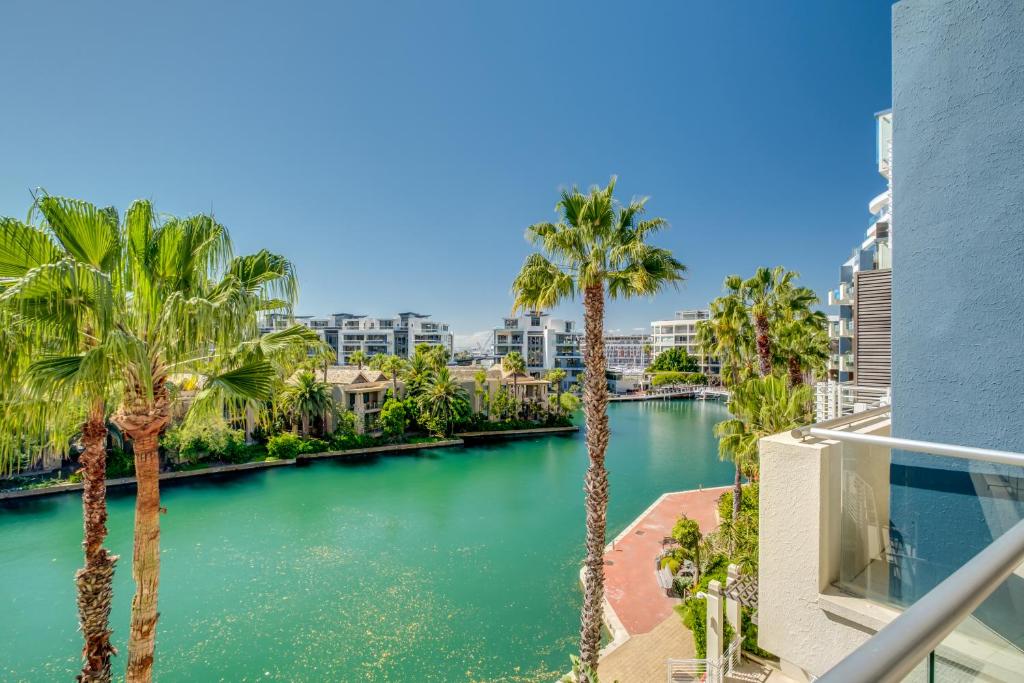 a view of a river with palm trees and buildings at 308 Juliette in Cape Town