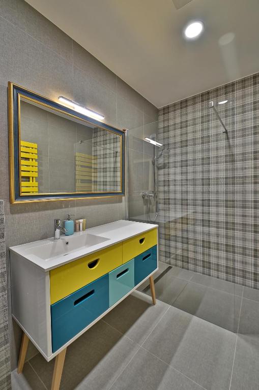 a bathroom with a sink and a shower at Hotel Pod Bránou in Bardejov