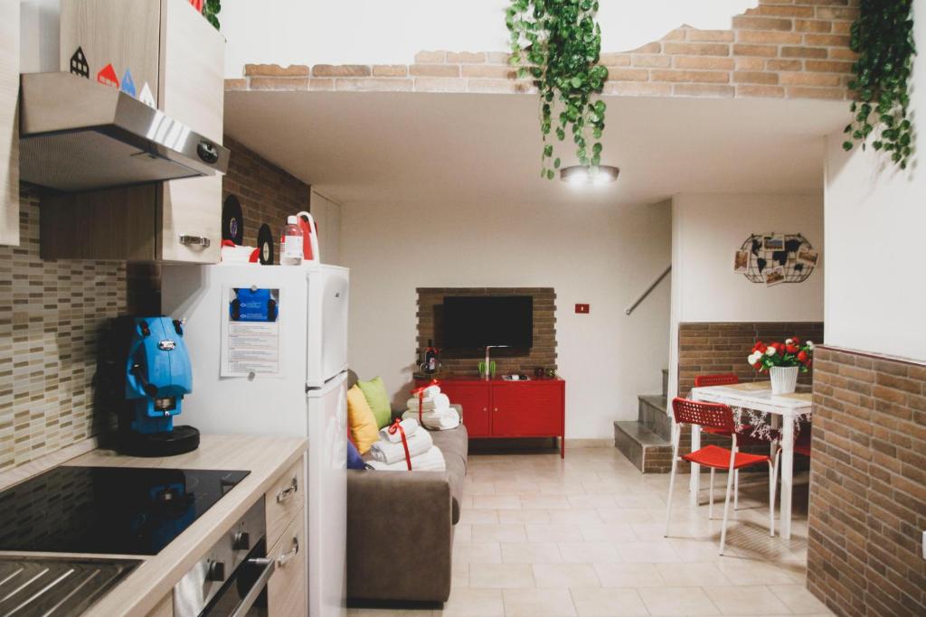 a kitchen and a living room with a couch at Frizzi & Lazzi House in Naples