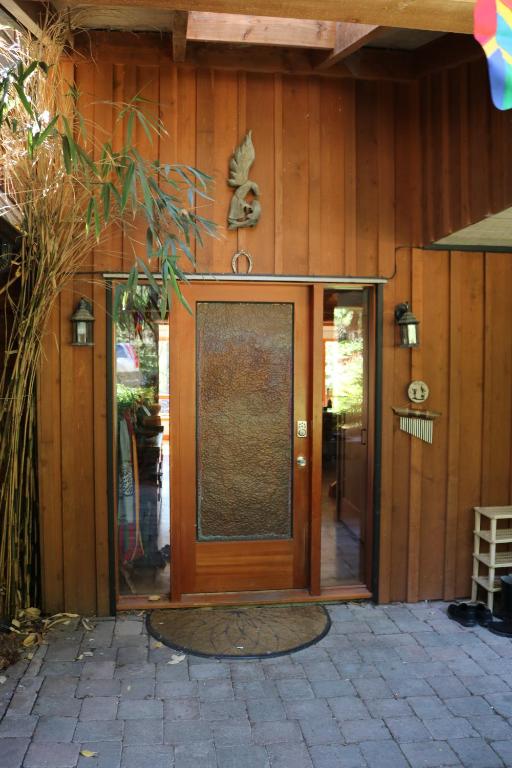 a front door of a house with a glass at Five Elements Lodge B&B with Outdoor Spa in Fernwood
