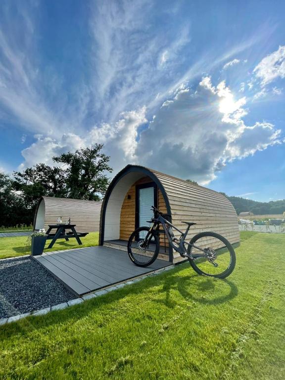 a bike parked in front of a small tent at Eastridge Glamping - Camping Pods in Shrewsbury