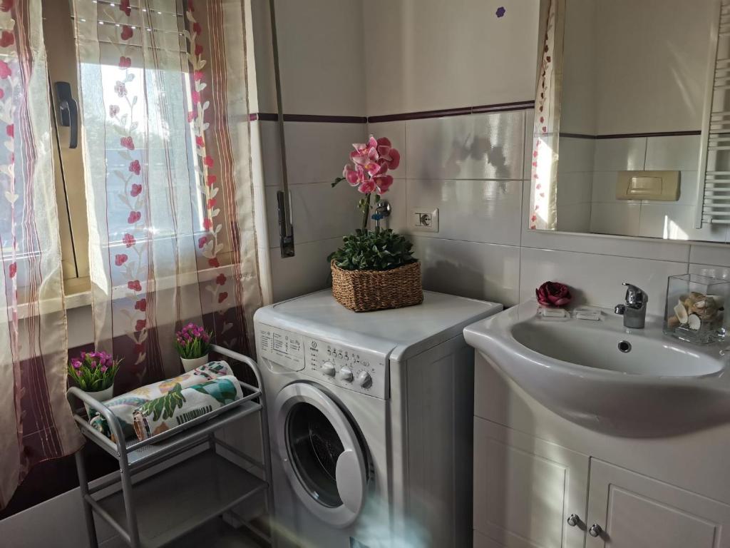 eine Waschküche mit einer Waschmaschine und einem Waschbecken in der Unterkunft Bnbook-L'appartamento di Gio' in Rho
