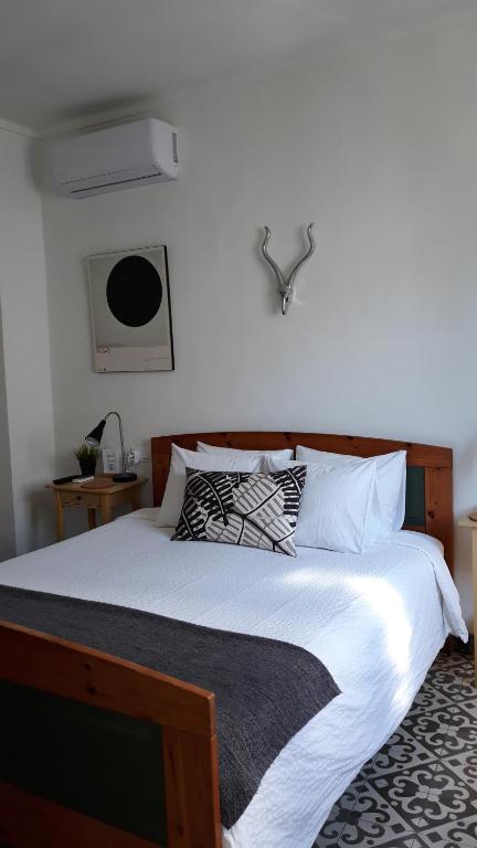 a bedroom with a large bed with white sheets at No 31 Bed & Breakfast in Olvera