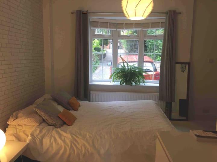 a bedroom with a white bed and a window at Chartleigh in Southampton