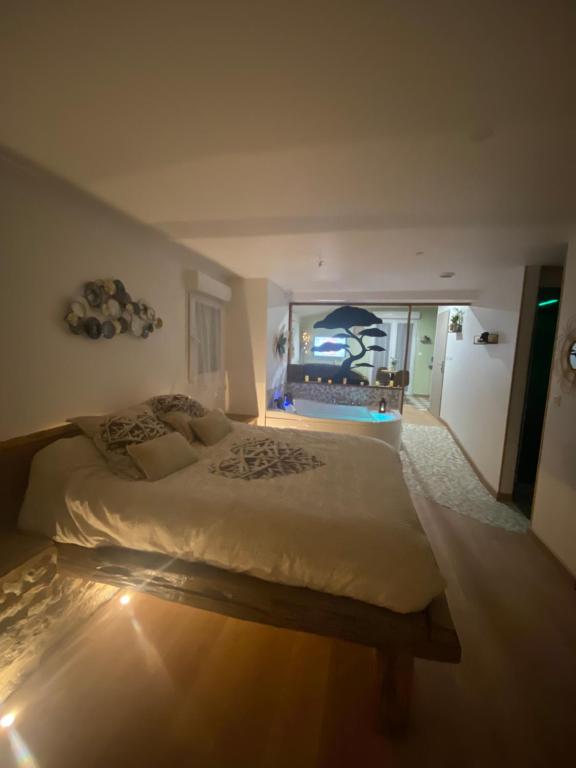 a bedroom with a large bed with a aquarium in it at Vite, au bien-être in Vitteaux