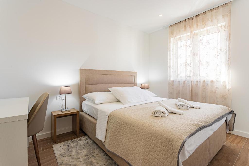Posteľ alebo postele v izbe v ubytovaní Apartmani Benzon
