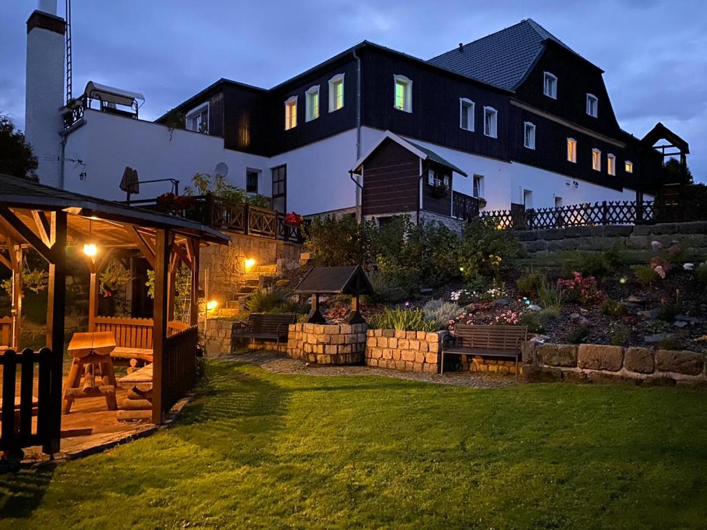 Una casa grande con un jardín enfrente. en Penzion Hubertus Doubice, en Doubice