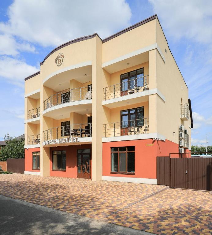 an apartment building with balconies on a street at Borys Hotel Boryspil Airport in Boryspil