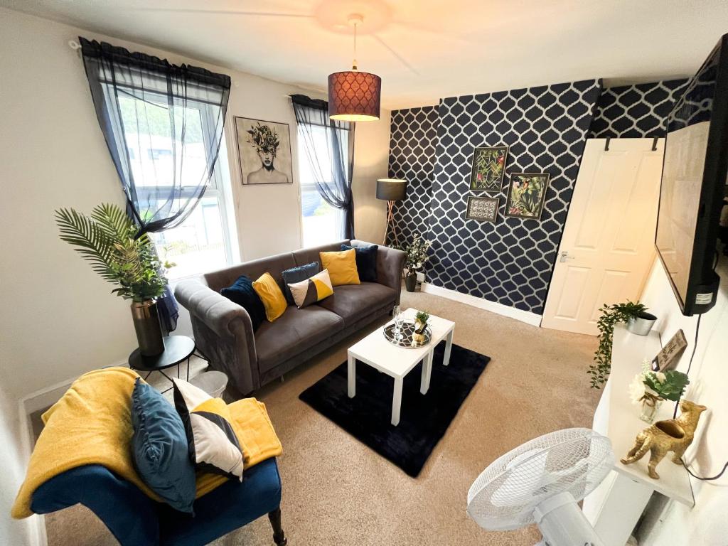 a living room with a couch and a table at Gillingham Centre Modern Apartment in Gillingham