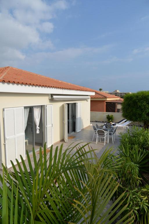 a house with a patio with tables and chairs at Villa Erna Relax Dream Holiday in Callao Salvaje