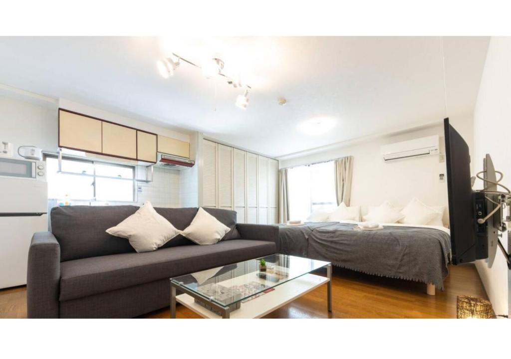 a living room with a couch and a table at Union Shin-Osaka 3F - Vacation STAY 12037 in Osaka