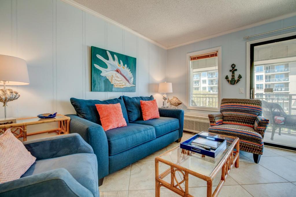 a living room with a blue couch and chairs at Ocean Dunes Villa 404, 2 Bedroom, Ocean Front, Pool, Sleeps 6 in Hilton Head Island