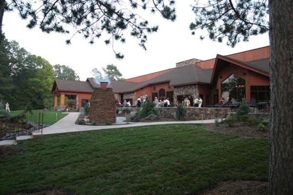 a large building with people sitting outside of it at Balsam Lake Lodge in Balsam Lake