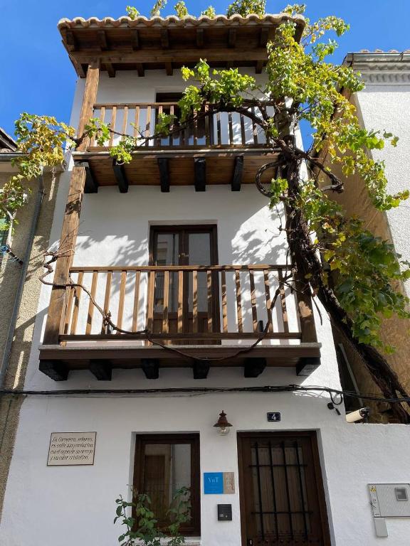 a building with a wooden balcony on top of it at La Corredera in Candeleda