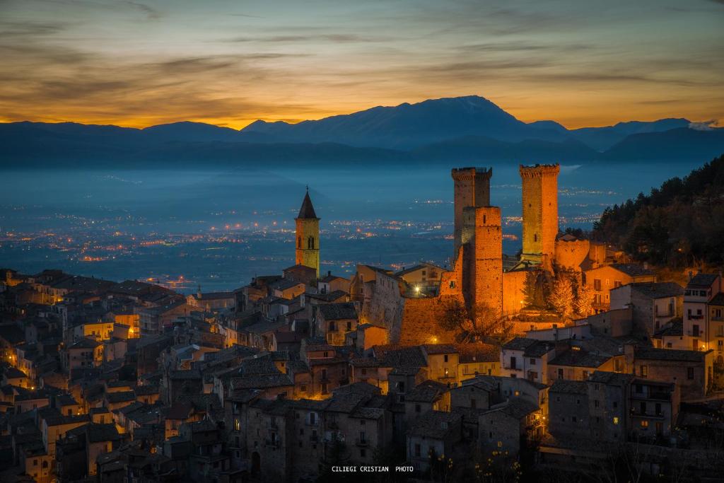 a cityscape of a city at night with a sunset at Pacentro Dimora del Castello in Pacentro