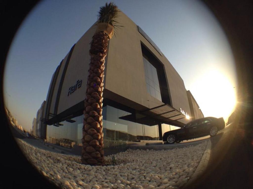 a palm tree in front of a building at Rafa Hotel Apart in Riyadh