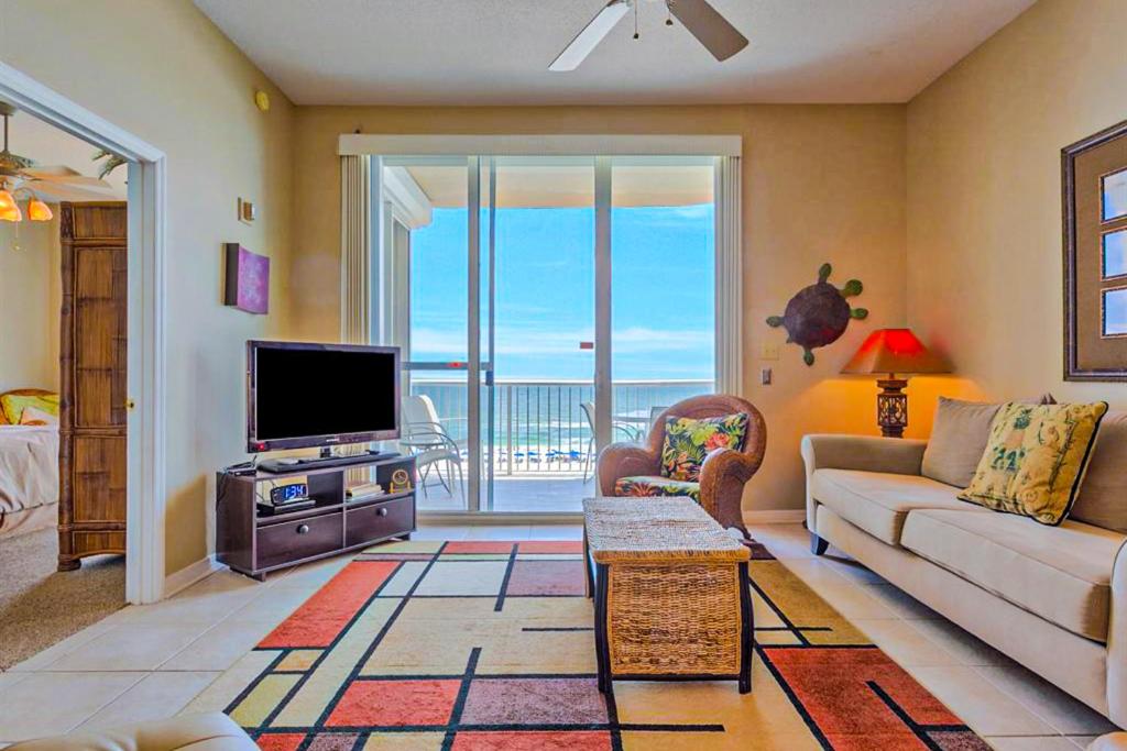 a living room with a couch and a tv at Spanish Key 408 in Pensacola