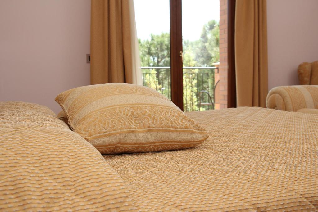 Posteľ alebo postele v izbe v ubytovaní Hotel Panoramic Montepulciano