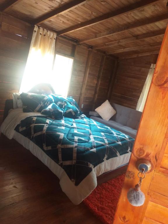 Postel nebo postele na pokoji v ubytování Cabaña Sueños Dorados