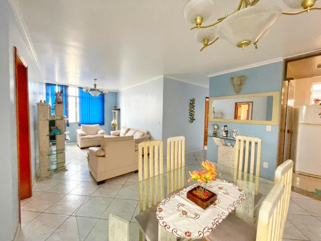 a dining room and living room with a table and chairs at Apart 4 quartos Praia do Forte e Canal in Cabo Frio