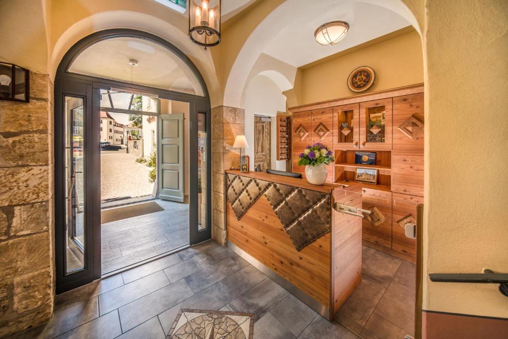 an entrance to a home with a wooden door and a hallway at Hotel Freyhof in Freiberg