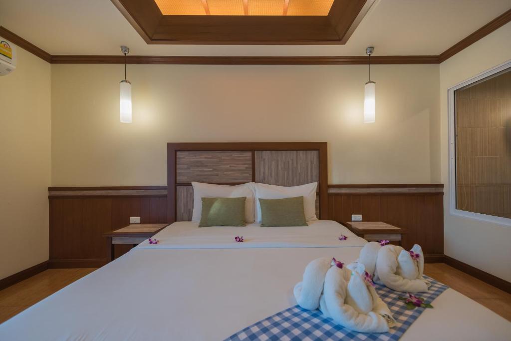 Кровать или кровати в номере Mac Resort Hotel
