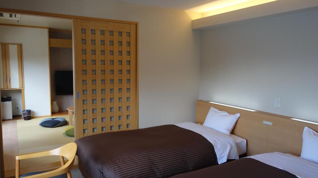 Postel nebo postele na pokoji v ubytování Hotel New Century