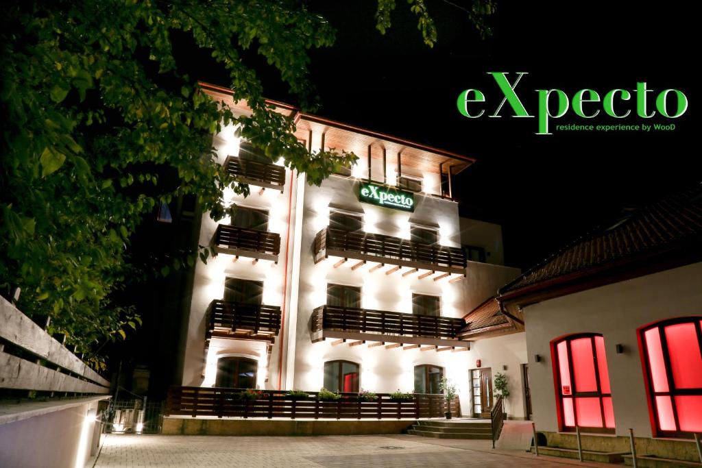 a lit up building with a sign on it at Expecto Apartments in Sinaia