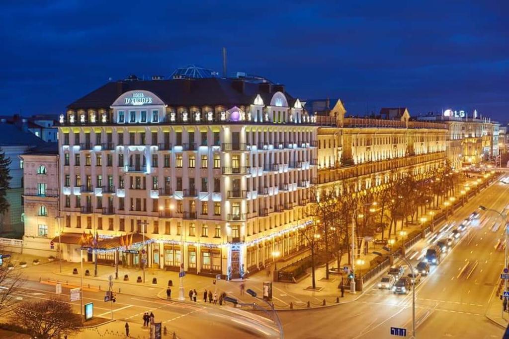 a large building in a city at night at Europe Hotel in Minsk