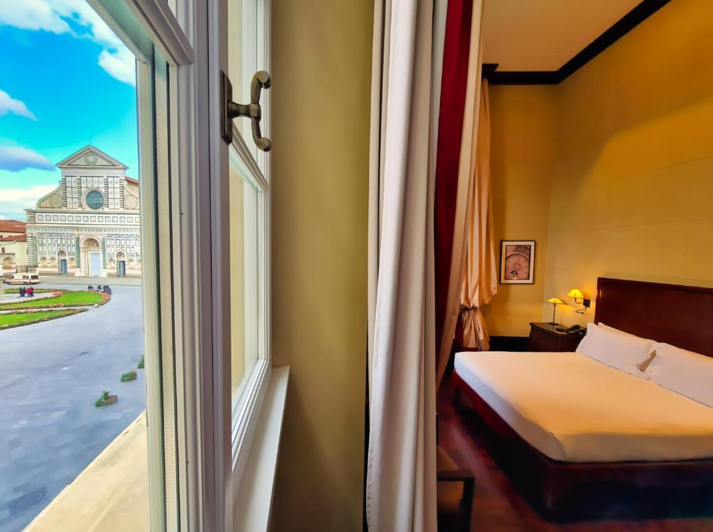 Postel nebo postele na pokoji v ubytování Hotel L'Orologio Firenze - WTB Hotels